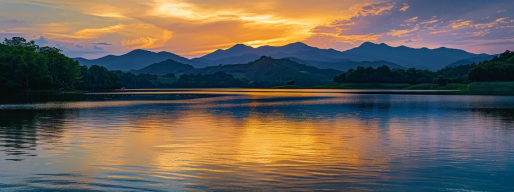 a breathtaking sunset casts a warm golden glow over a serene mountain lake, where the vibrant reflections of towering peaks blend seamlessly with the tranquil water's surface.