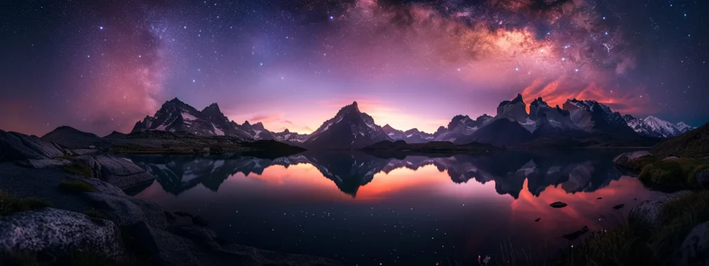 a breathtaking twilight landscape reveals a tranquil lake reflecting vibrant hues of orange and purple, framed by silhouetted mountains under a starry sky.
