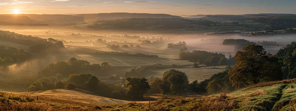 a serene landscape unfolds at dawn, showcasing a misty valley enveloped in soft, golden light, with towering mountains reflecting the warm hues of the rising sun.