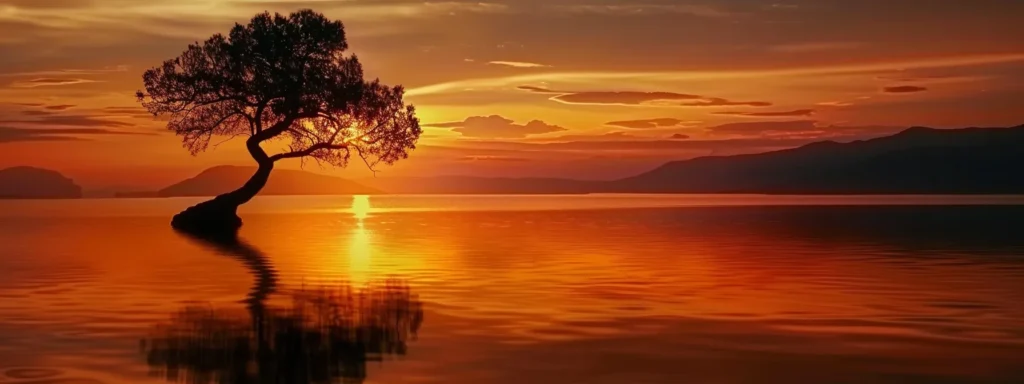 a vibrant sunset casts a warm golden glow over a tranquil lake, where the silhouette of a solitary tree stands gracefully at the water's edge, reflecting the dazzling colors of the sky.