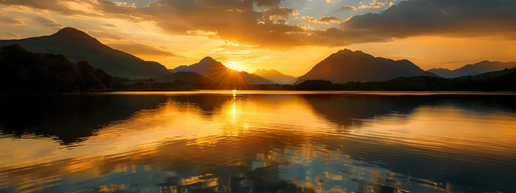 a mesmerizing sunset casts golden hues over a tranquil lake, reflecting the vibrant colors in the water, while silhouettes of majestic mountains loom in the background.